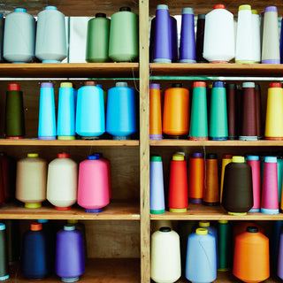 Lots of colourful yarn on a shelf