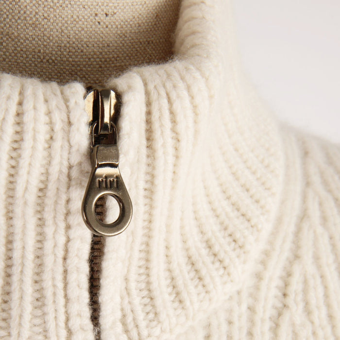 Close-up of a zipper on a beige fabric background