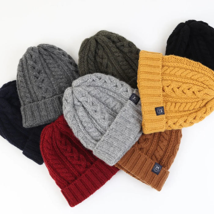 Set of knit beanies in various colors on a white background