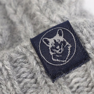 Navy blue label with a logo on a textured grey fabric background