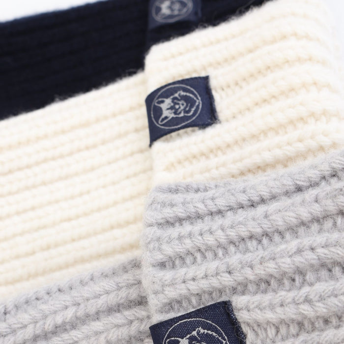 Close-up of a knitted fabric with a brand label on a white background