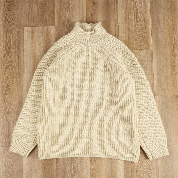 roll neck pullover on a wooden floor