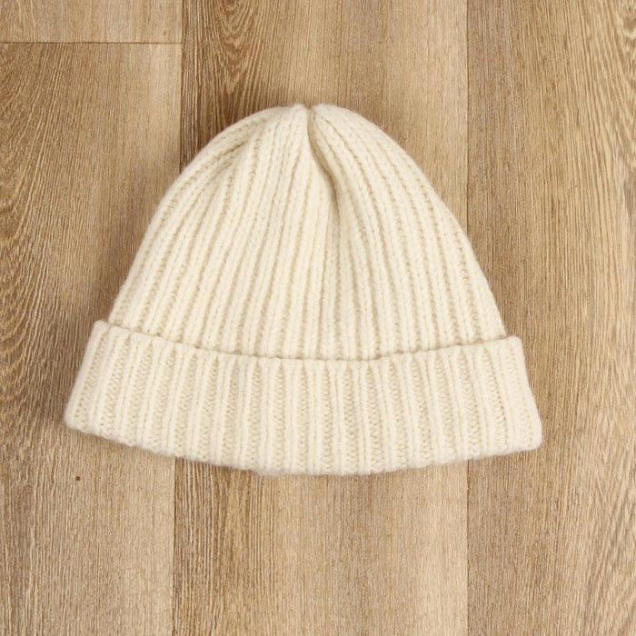 white rib hat on a wooden floor