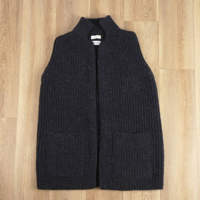 Dark grey ribbed knit vest on a wooden floor
