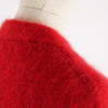 Close-up of a red mohair knitted garment on a mannequin with shoulder detail