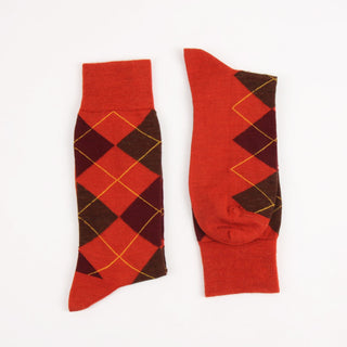 Orange and wine argyle pattern socks on a white background