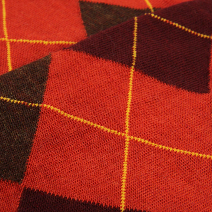Close-up of orange and wine checkered fabric with yellow stitching