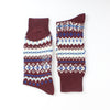 Pair of maroon socks with white and blue pattern on a white background