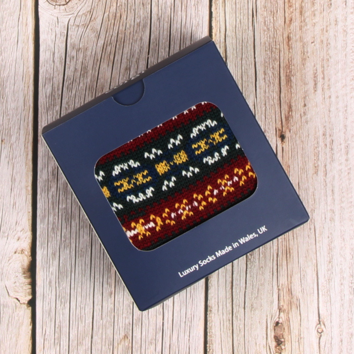 Pack of luxury socks in a blue box on a wooden surface