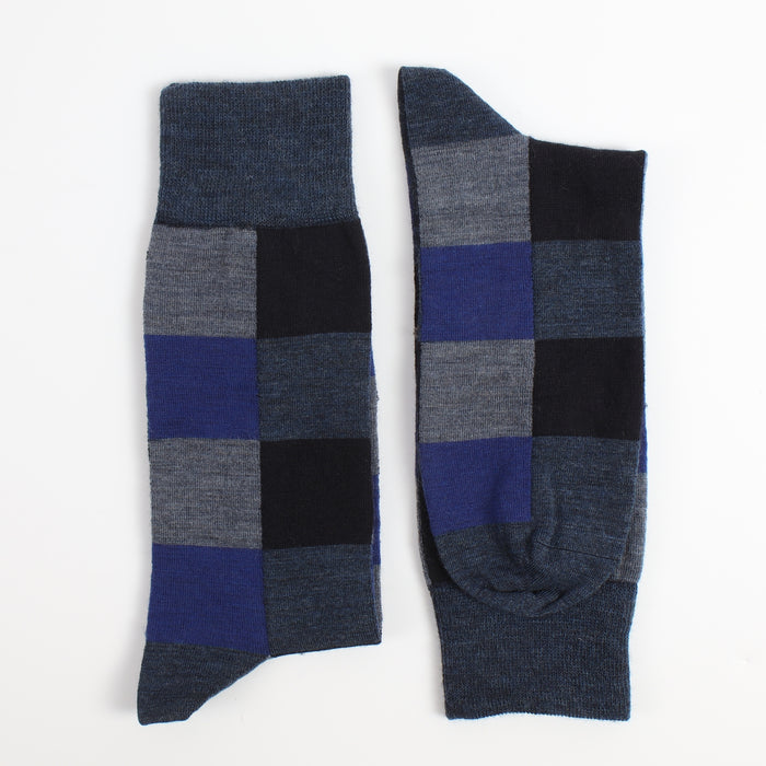Pair of checkered socks with blue, gray, and black pattern on a white background