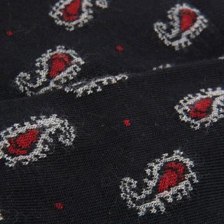 Close-up of a navy fabric with red and white paisley patterns.