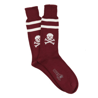 Maroon socks with skull and crossbones design on a white background