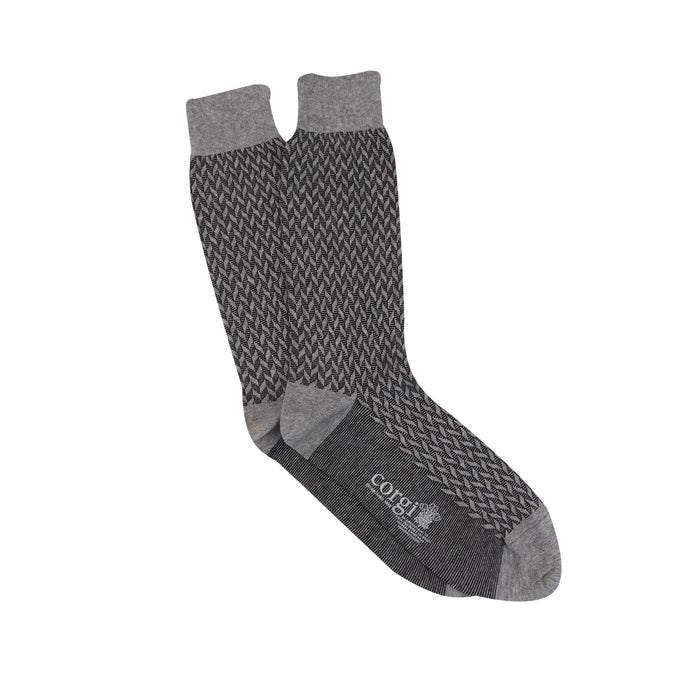 A pair of men's formal socks with a geometric pattern in silver and charcoal colors on a white background