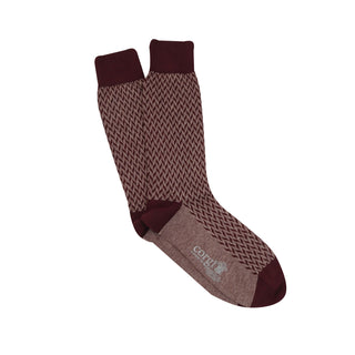 A pair of men's formal socks with a geometric pattern in wine and port colours on a white background.