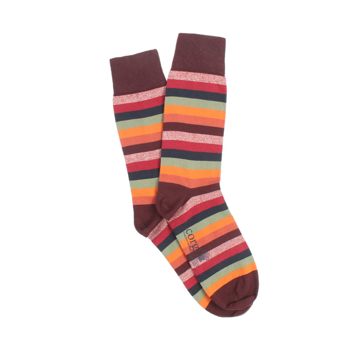 Colourful mix of red toned striped socks photographed on a white background