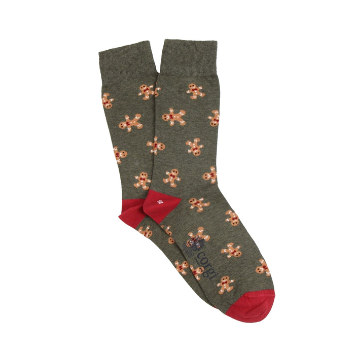Loden green socks with gingerbread man patterns and red heel and toes on a white background
