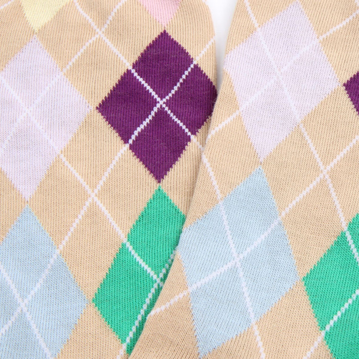 Close-up of argyle patterned socks with pastel colors on a beige background