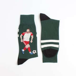 Green sock with a soccer player design photographed on a white background