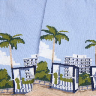 Socks with a design of palm trees and buildings on a blue background