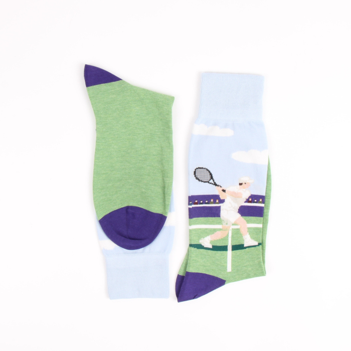 Green and purple sock with a tennis player design on a white background