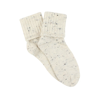 Pair of cream socks with speckled pattern on a white background