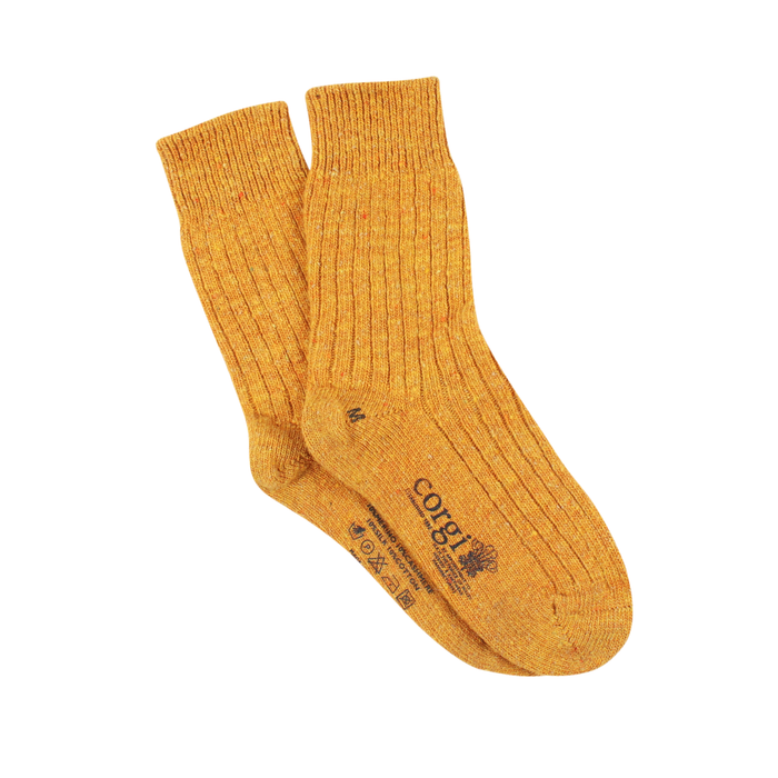Pair of mustard yellow socks on a white background