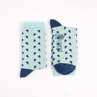 Pair of light blue socks with a mini pelican all over pattern photographed on a white background