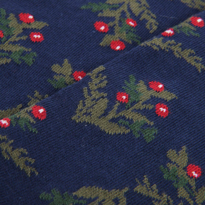 Navy fabric with green leaf and red berry pattern