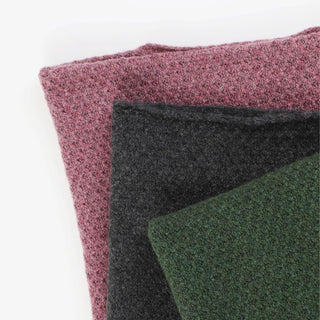 stacked ponchos on a white background