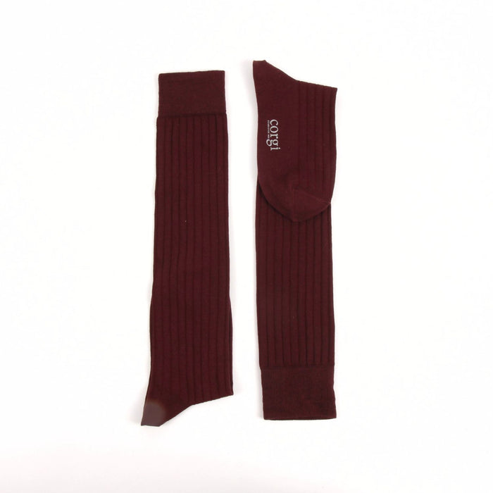 Pair of wine knee-high socks on a white background