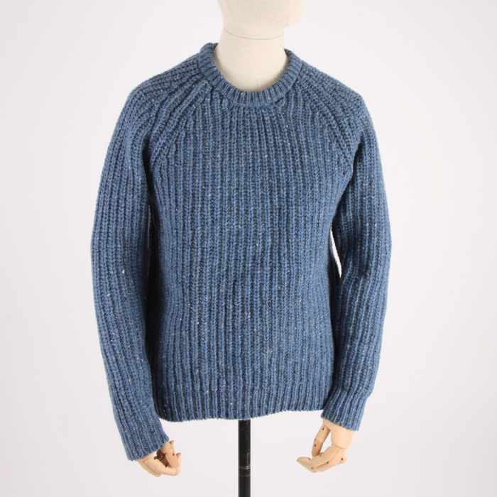 Blue knitted sweater on a mannequin against a white background
