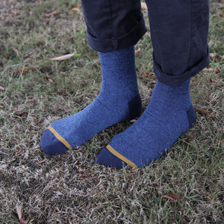 Blue socks with yellow trim worn on grass
