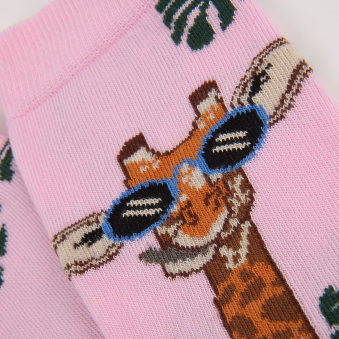 Colourful socks with a giraffe design on a pink background