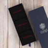 Navy socks with 'WILLIAM' embroidery in red text, inside an open navy box with 'Corgi' branding.