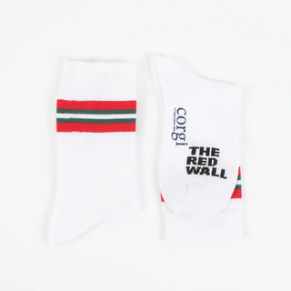 A pair of white crew socks with red and green stripes on the calf, featuring text 'RED WALL' and the flag of Wales.