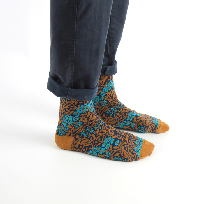 person wearing william morris patterned socks