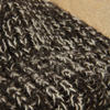 Close-up of a textured brown fabric on a wooden surface