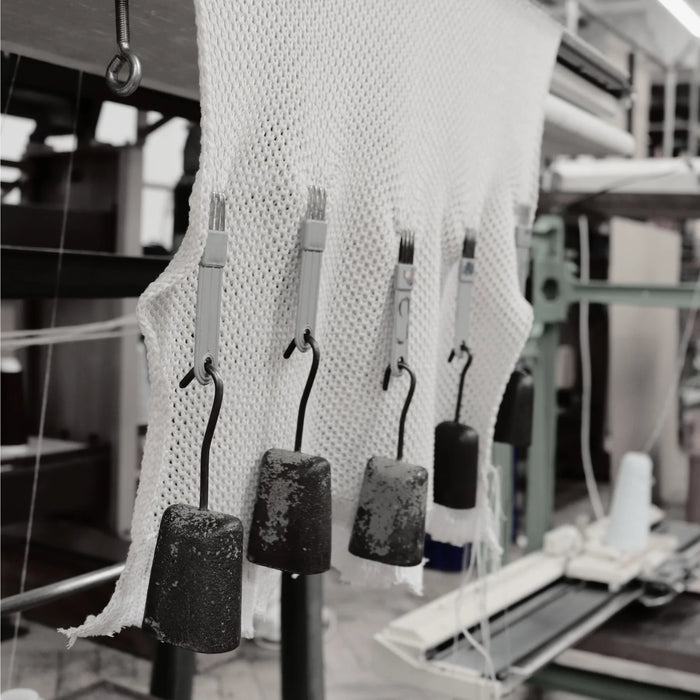 Textile production process with fabric and machinery in a factory setting