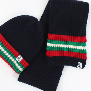 Navy knit beanie and scarf set with red and green stripes on a white background