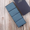 Set of denim Brecon socks with a Corgi box on a wooden surface
