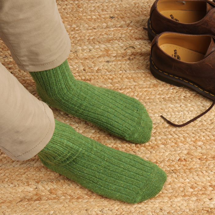 Donegal socks on a rug with a pair of brown shoes.