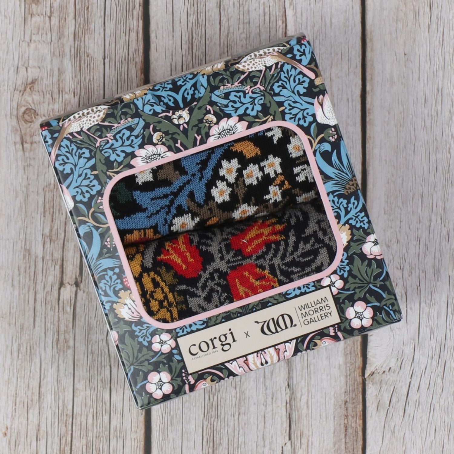 A box of Men's 2-Pair William Morris Cotton Socks with a floral and geometric pattern design.