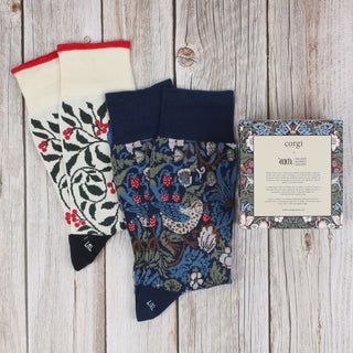 2 pairs of William Morris socks on a wooden background with gift box