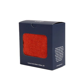 Box of orange gloves with a visible brand name on a white background