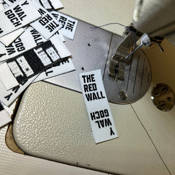Red Wall labels on a sewing machine.