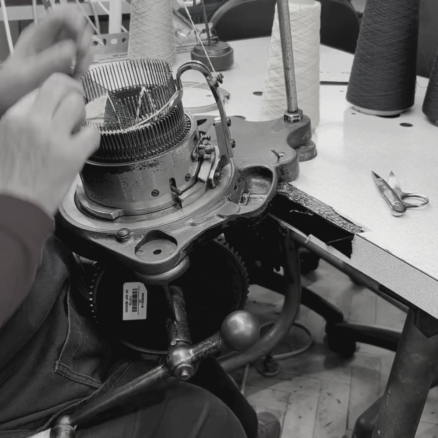 video of hand cable socks being made on a hand operated machine in the factory