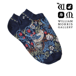 Navy blue socks with intricate floral pattern on a white background, featuring the William Morris Gallery logo.