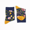 Pair of socks with floral pattern and yellow accents on a white background
