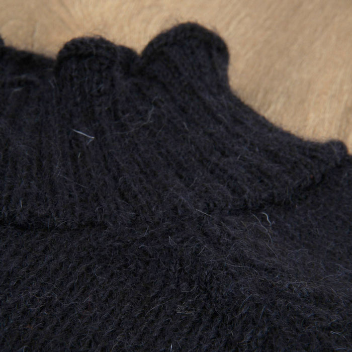 Close-up of dark blue knitted jumper showing the neck detail