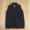 Dark grey ribbed knit vest on a wooden floor